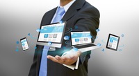 Businessman with computer phone and tablet in his hand
