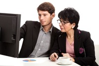 Coworkers during analysing computer data in office